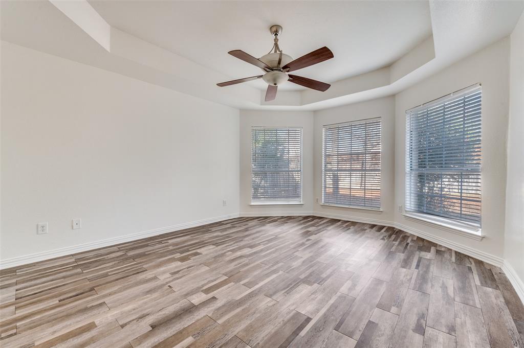 9611 Cliffside Drive Irving, TX 75063 - Photo 14 of 24 a view of an empty room with wooden floor and a window