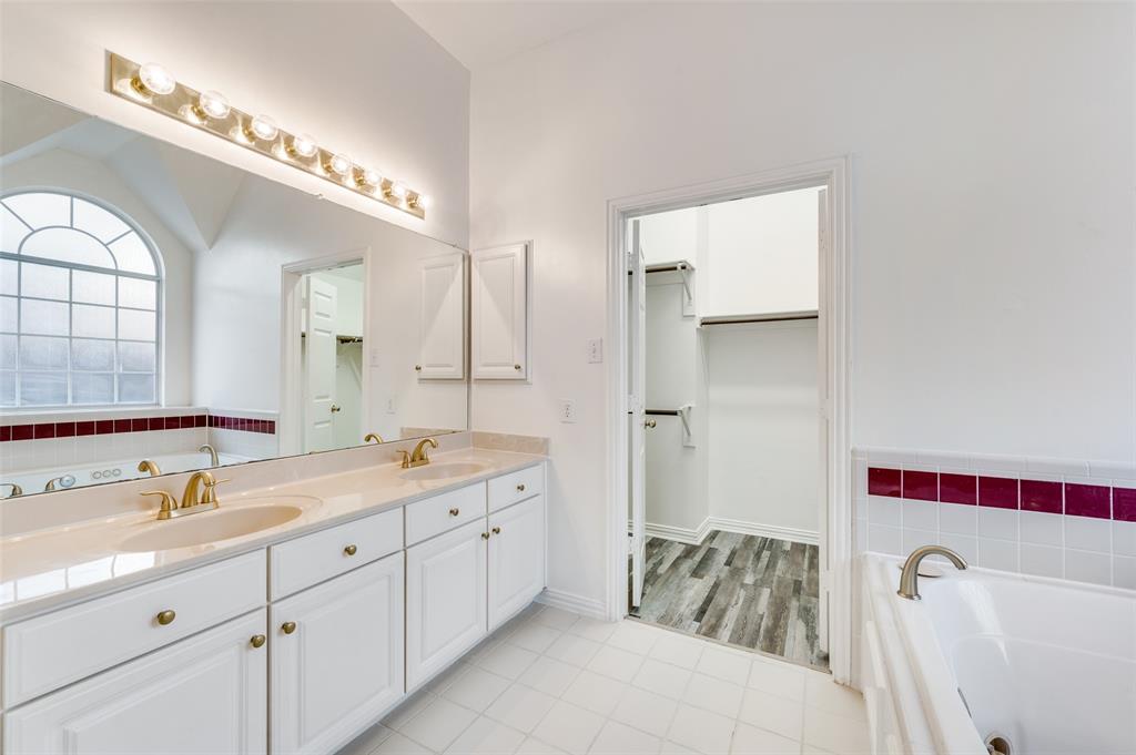 9611 Cliffside Drive Irving, TX 75063 - Photo 16 of 24 a spacious bathroom with a double vanity sink mirror and bathtub