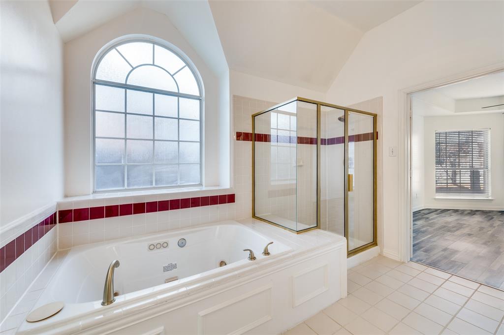 9611 Cliffside Drive Irving, TX 75063 - Photo 17 of 24 a bathroom with a bathtub and a shower