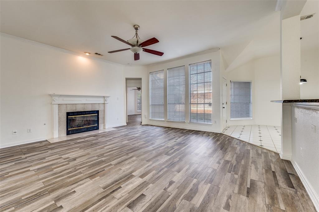 9611 Cliffside Drive Irving, TX 75063 - Photo 6 of 24 a view of empty room with wooden floor and fireplace