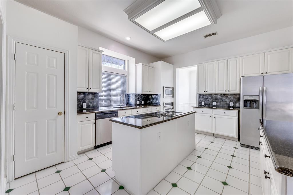 9611 Cliffside Drive Irving, TX 75063 - Photo 10 of 24 a kitchen with white cabinets and white appliances