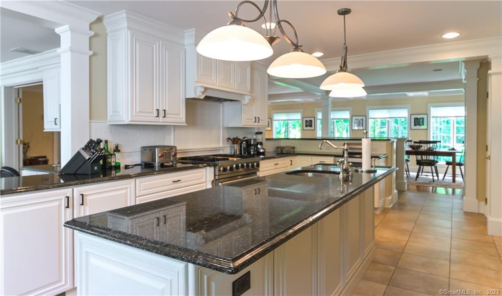 12 West Mountain Road Sharon, CT 06069 - Photo 11 of 33 a kitchen with stainless steel appliances granite countertop a sink a stove and a wooden cabinets