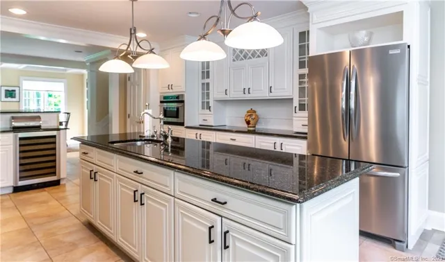 a kitchen with stainless steel appliances a sink and a refrigerator