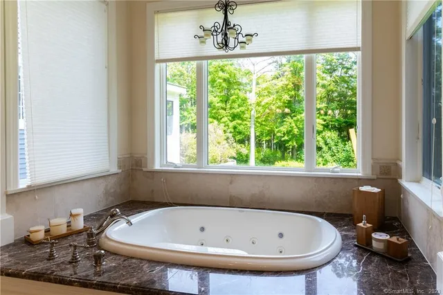 a bath tub sitting in a bathroom next to a window
