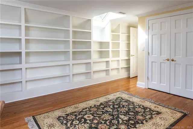 a view of a room with wooden floor and cabinet