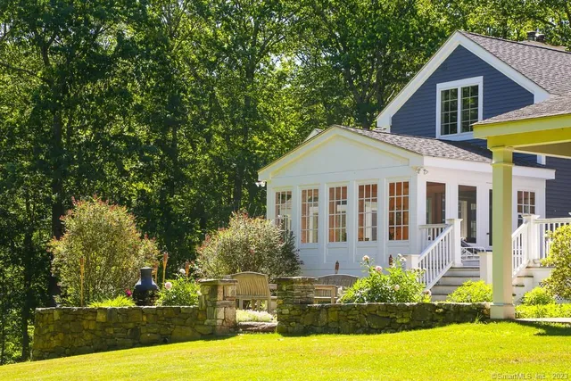 a front view of a house with a yard table and chairs