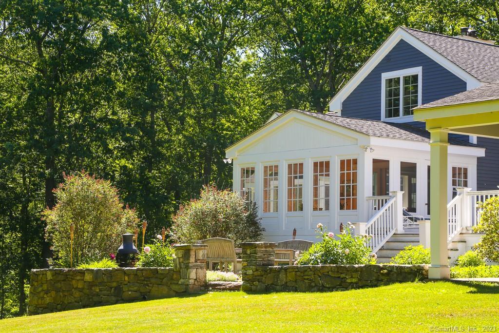 12 West Mountain Road Sharon, CT 06069 - Photo 31 of 33 a front view of a house with a yard table and chairs