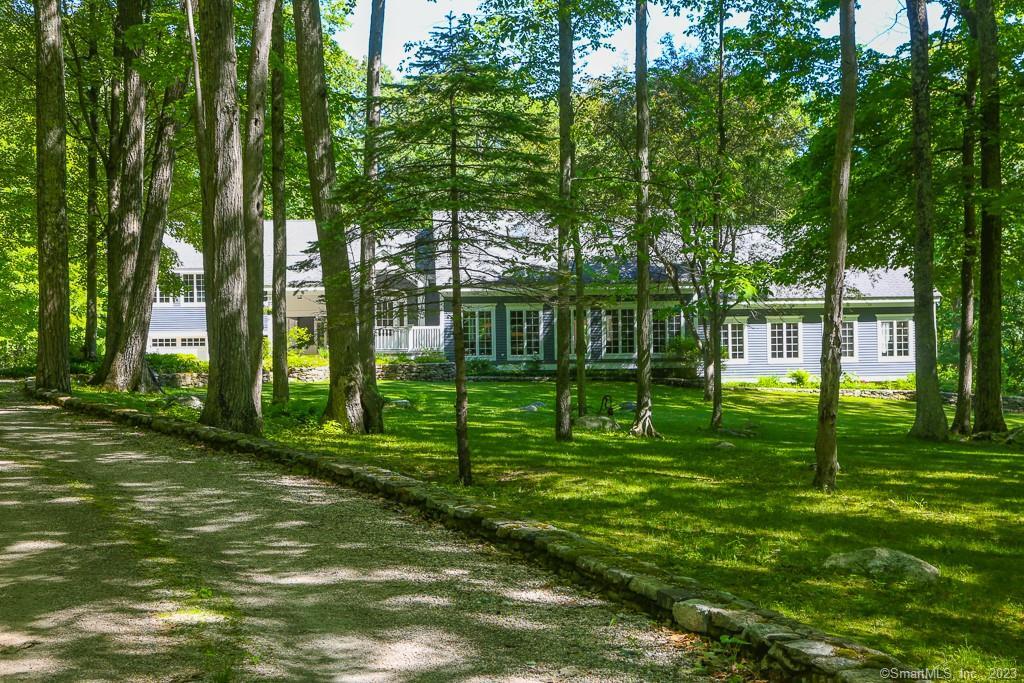 12 West Mountain Road Sharon, CT 06069 - Photo 4 of 33 a view of a big yard with plants and large trees