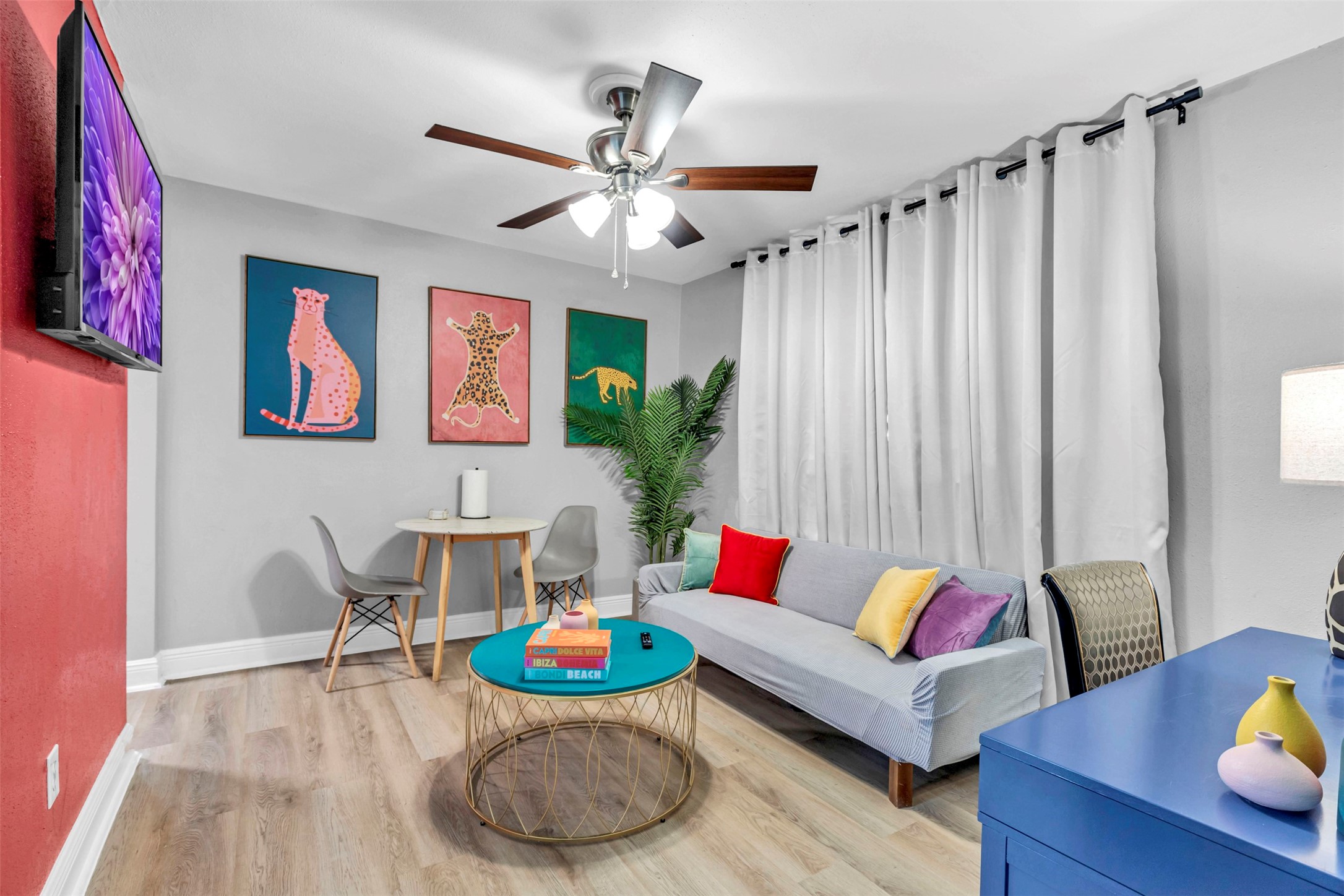 a living room with furniture and wooden floor