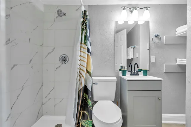a white toilet sitting next to a bathroom sink