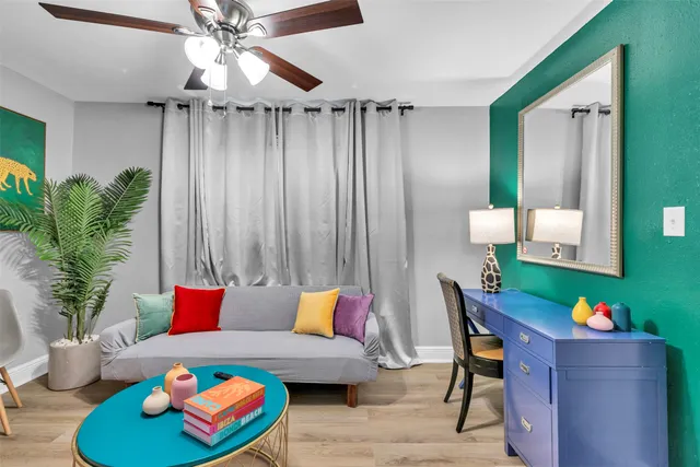 a living room with furniture and a potted plant
