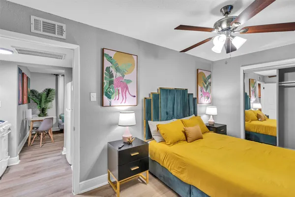 a bedroom with a bed and wooden floor