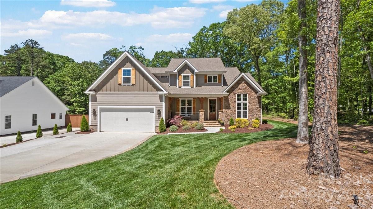 10154 Jim Sossoman Road Midland, NC 28107 - Photo 1 of 44 a front view of a house with garden