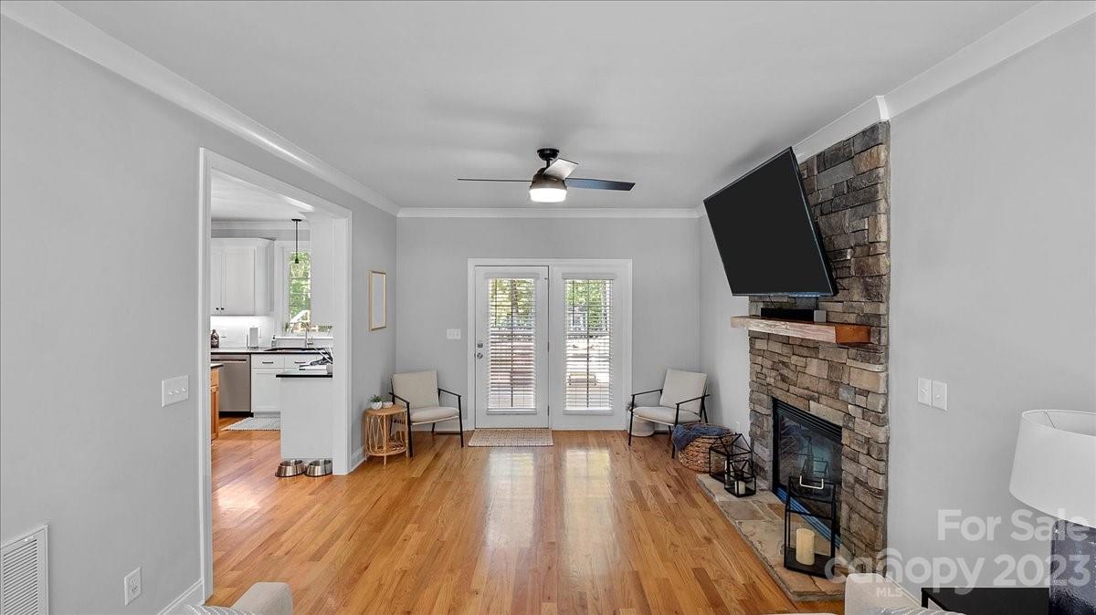 10154 Jim Sossoman Road Midland, NC 28107 - Photo 20 of 44 a living room with fireplace furniture a flat screen tv and a fireplace