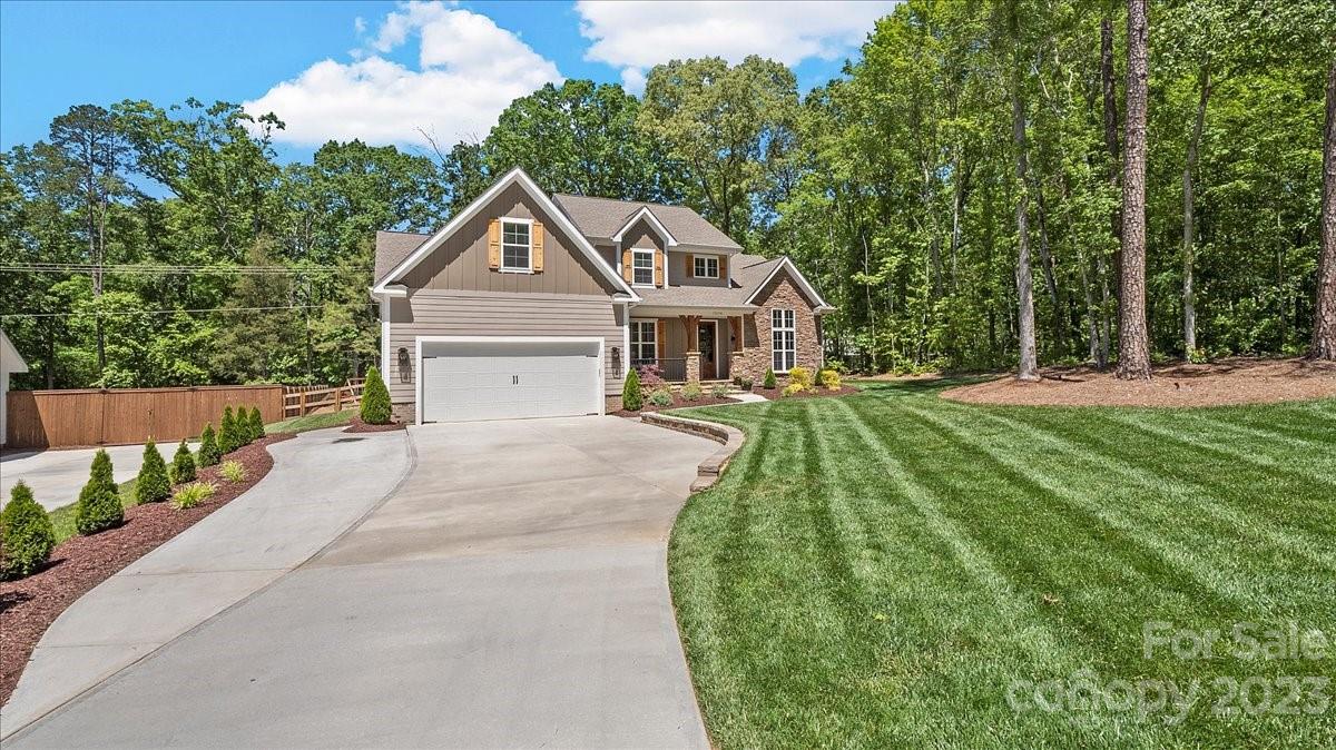 10154 Jim Sossoman Road Midland, NC 28107 - Photo 2 of 44 a front view of a house with a yard and trees