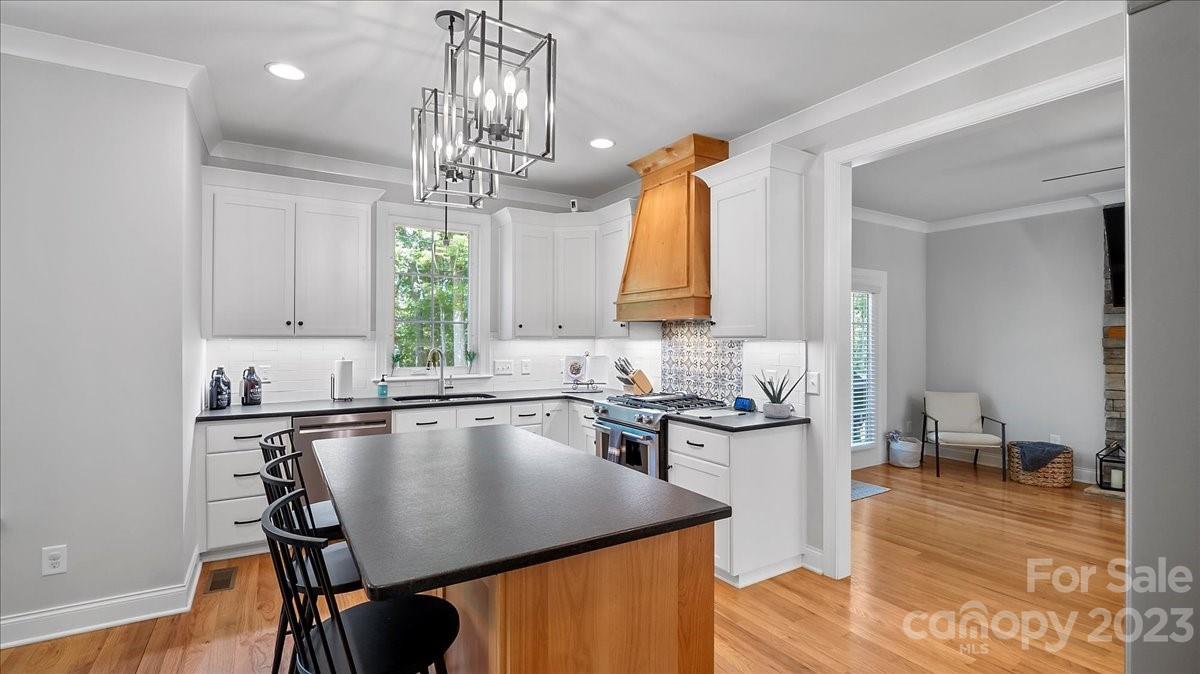 10154 Jim Sossoman Road Midland, NC 28107 - Photo 24 of 44 a kitchen with a sink a stove and cabinets