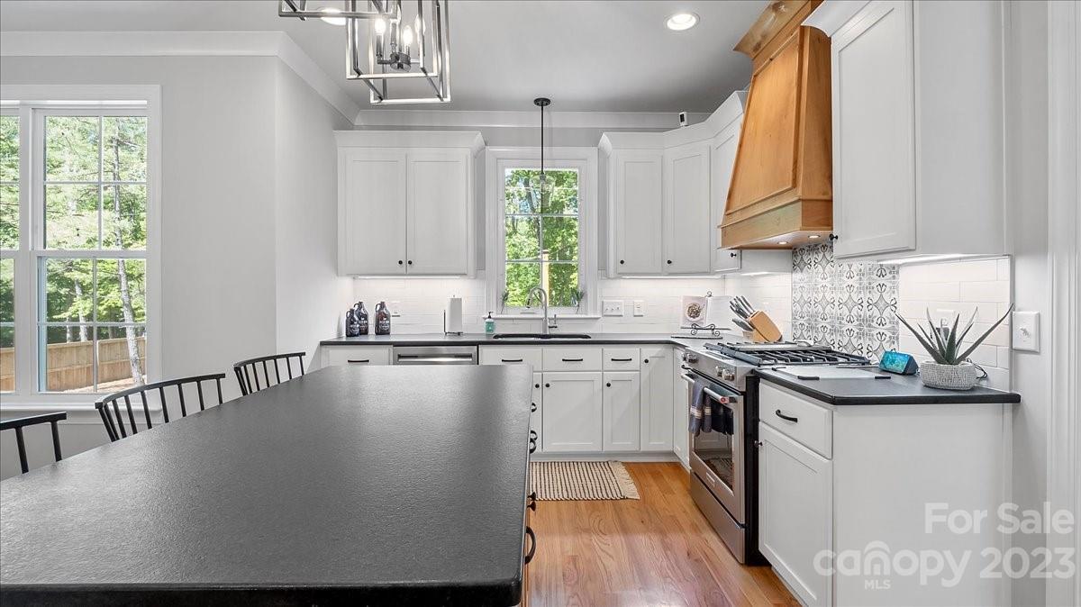 10154 Jim Sossoman Road Midland, NC 28107 - Photo 25 of 44 a kitchen with a sink a window and cabinets