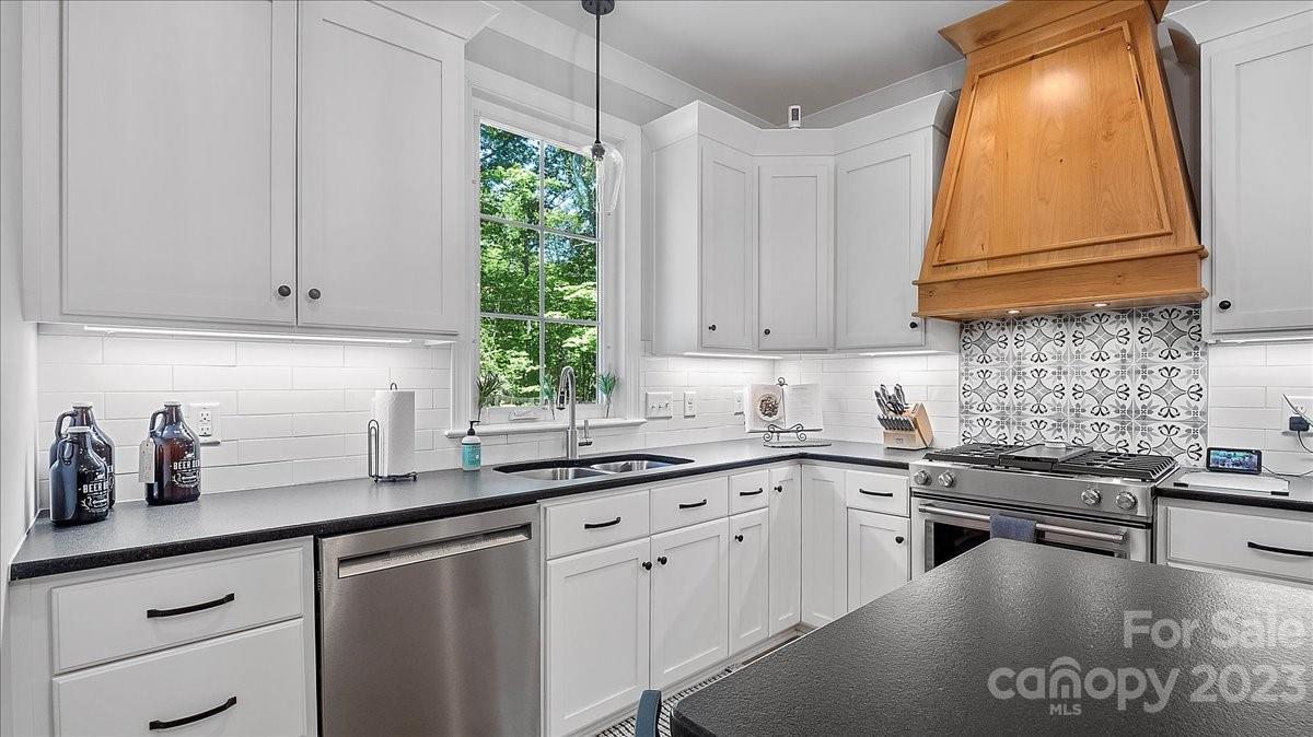 10154 Jim Sossoman Road Midland, NC 28107 - Photo 26 of 44 a kitchen with stainless steel appliances white cabinets and a sink