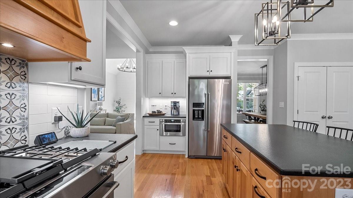 10154 Jim Sossoman Road Midland, NC 28107 - Photo 27 of 44 a kitchen with stainless steel appliances granite countertop a stove refrigerator and cabinets