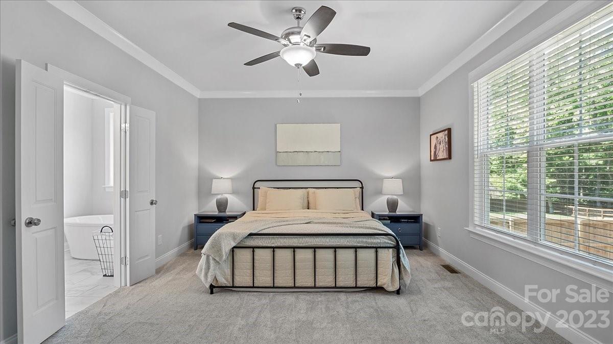 10154 Jim Sossoman Road Midland, NC 28107 - Photo 33 of 44 a bedroom with a bed and a large window