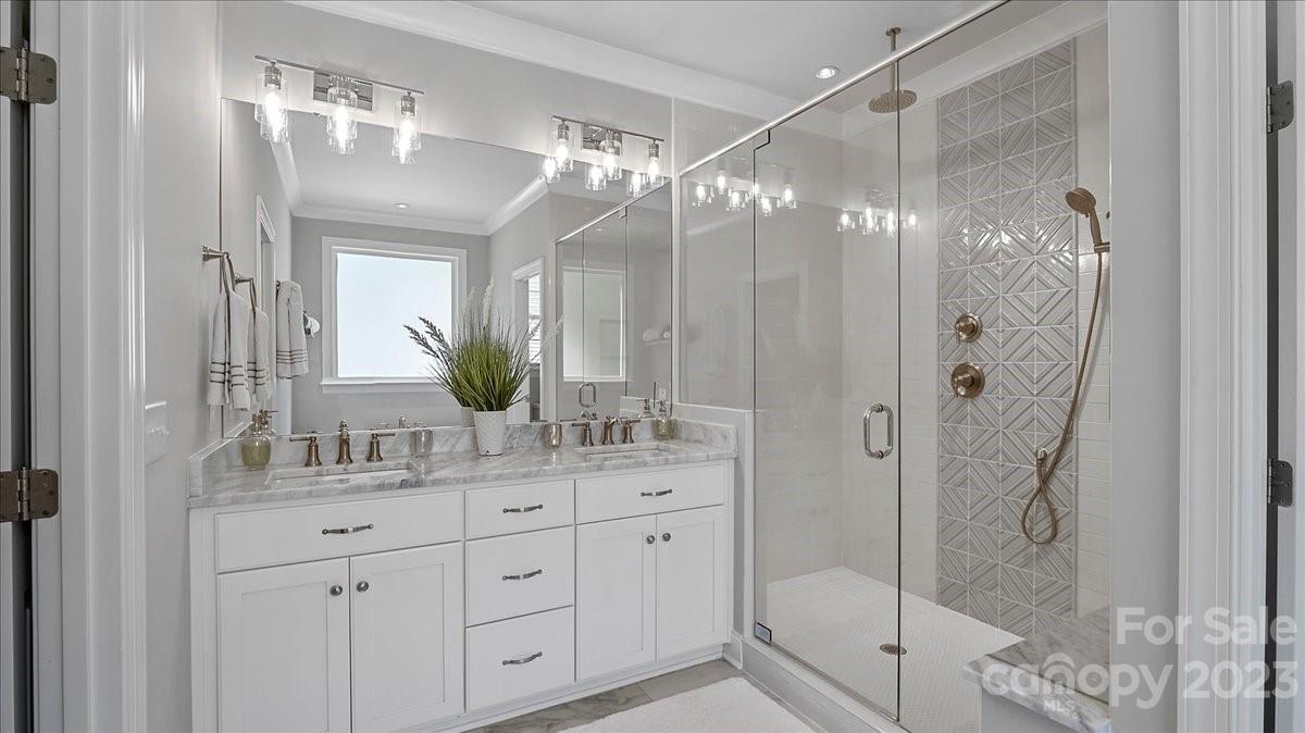 10154 Jim Sossoman Road Midland, NC 28107 - Photo 34 of 44 a bathroom with a double vanity sink mirror and shower