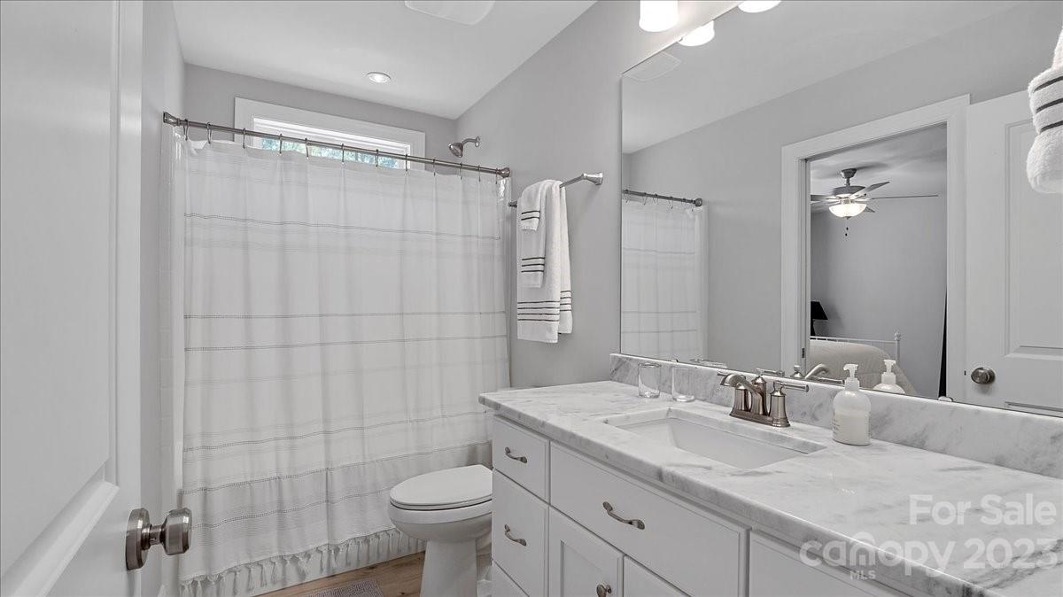 10154 Jim Sossoman Road Midland, NC 28107 - Photo 37 of 44 a bathroom with a double vanity sink toilet and shower