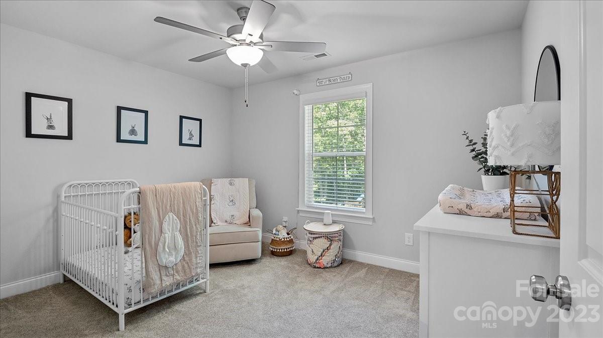 10154 Jim Sossoman Road Midland, NC 28107 - Photo 41 of 44 a bedroom with a bed and a table