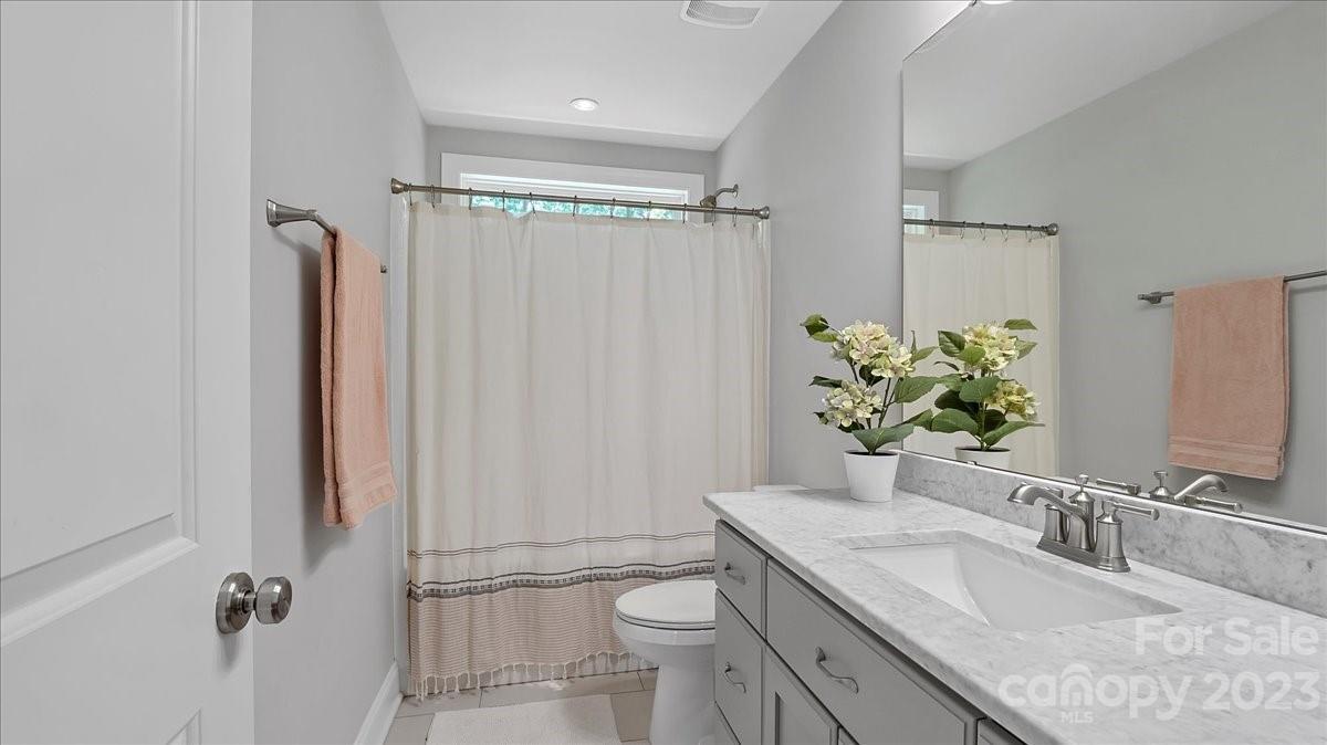 10154 Jim Sossoman Road Midland, NC 28107 - Photo 42 of 44 a bathroom with a granite countertop sink toilet and shower