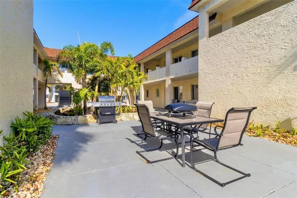 a view of a patio with table and chairs and potted plants