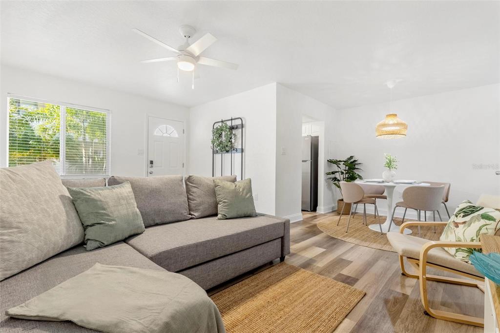 2704 2nd Street, Unit 2 Indian Rocks Beach, FL 33785 - Photo 5 of 32 a living room with furniture and a large window with garden view
