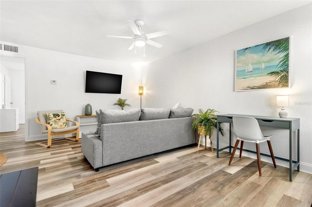 2704 2nd Street, Unit 2 Indian Rocks Beach, FL 33785 - Photo 7 of 32 a living room with furniture and a flat screen tv
