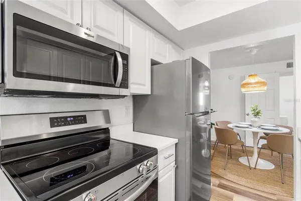 a kitchen with appliances and cabinets
