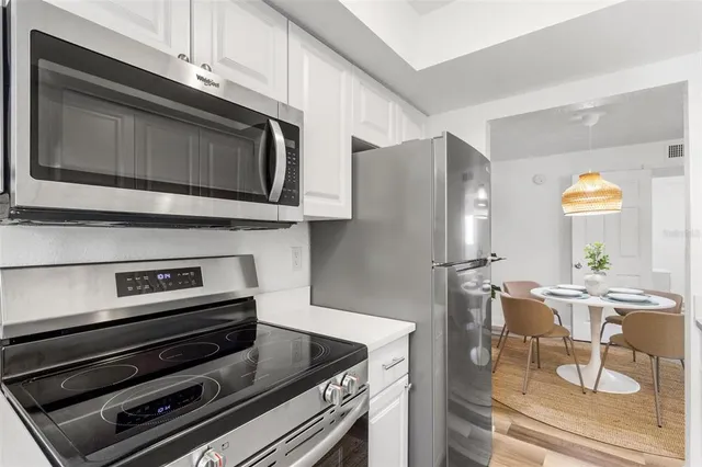 a kitchen with appliances and cabinets