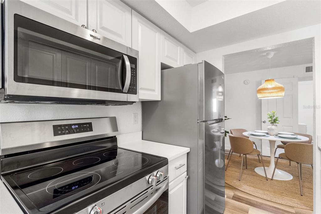 2704 2nd Street, Unit 2 Indian Rocks Beach, FL 33785 - Photo 9 of 32 a kitchen with appliances and cabinets