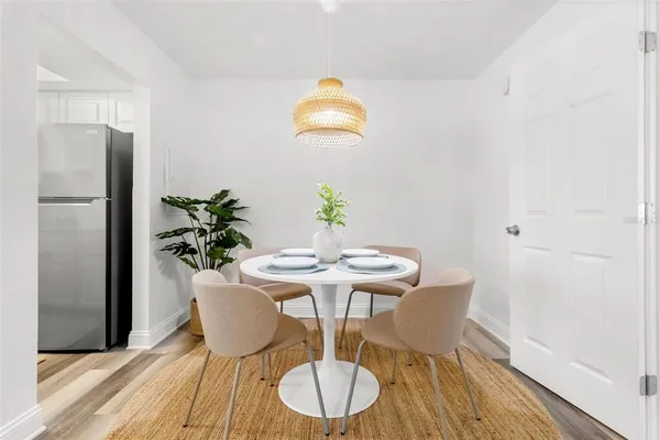 a view of a dining room with furniture and wooden floor
