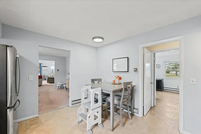 a view of a livingroom with dining room and furniture