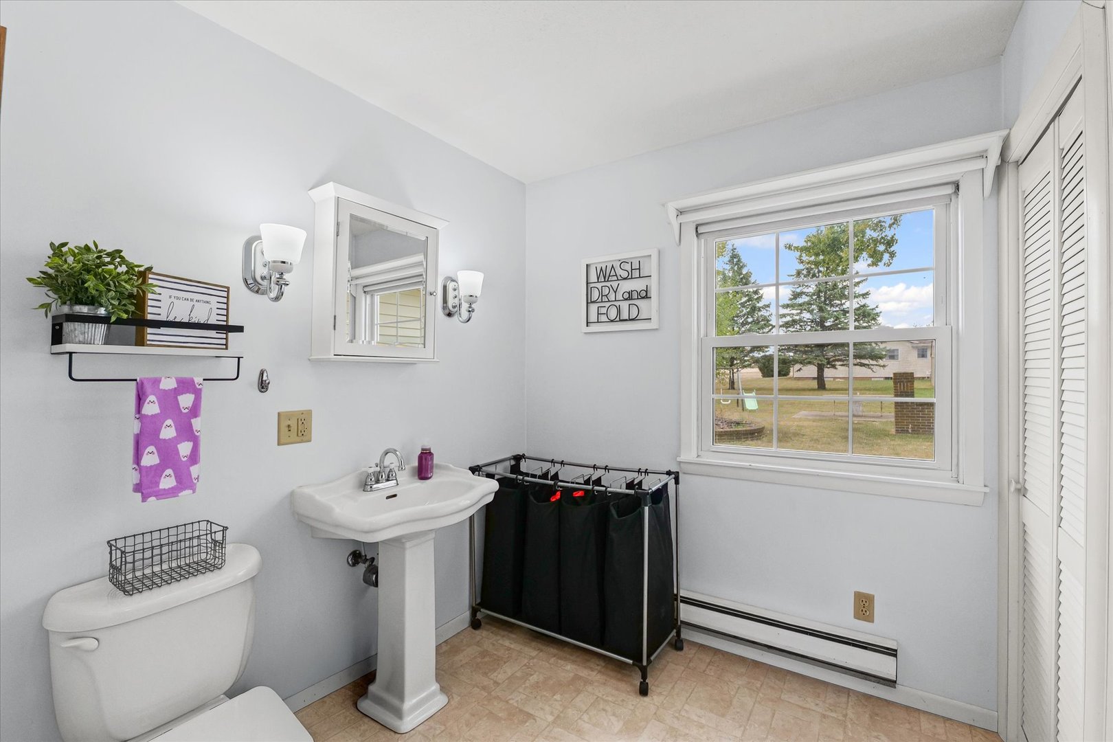 407 Church Street Royal, IL 61871 - Photo 16 of 31 a bathroom with a sink toilet and window