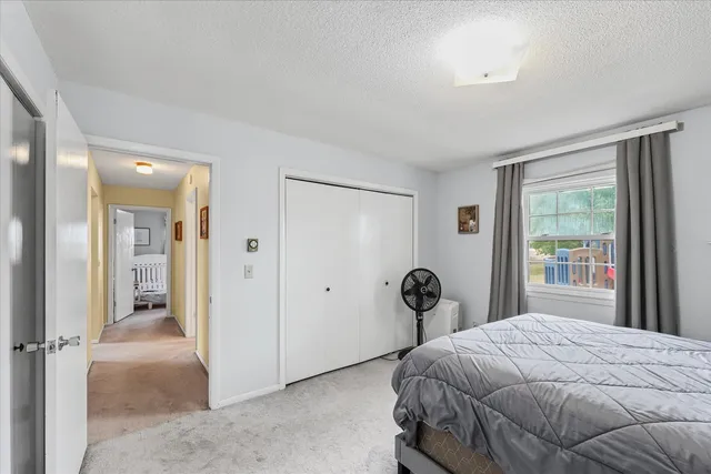 a bedroom with a bed and a large window