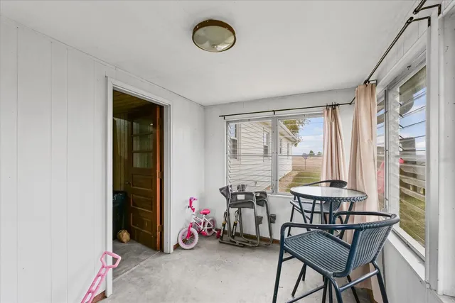 a view of a livingroom with furniture and a window