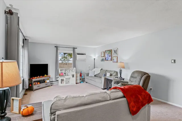 a bedroom with furniture and a flat screen tv