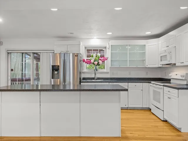 a kitchen with stainless steel appliances granite countertop a stove and cabinets