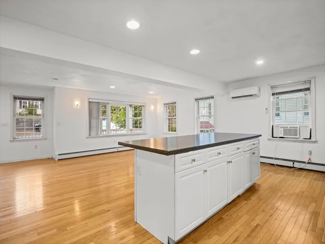 a large kitchen with granite countertop a large counter top and sink