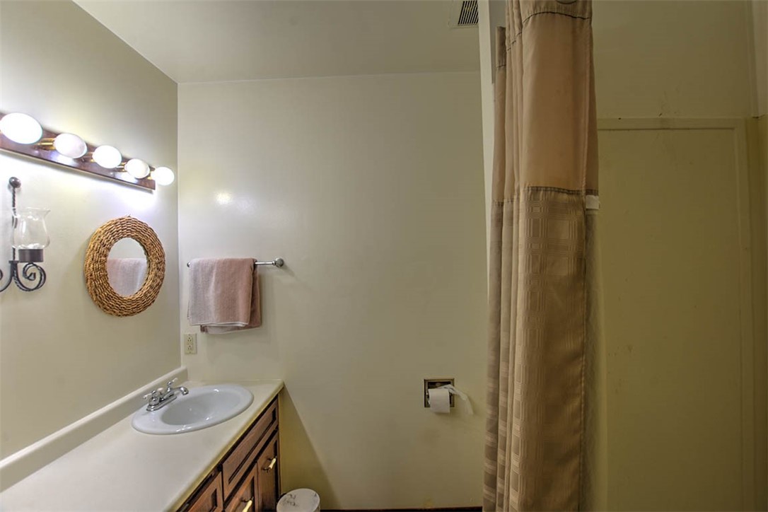 4425 Butler Drive Decatur, IL 62526 - Photo 17 of 22 a bathroom with a sink a mirror and shower