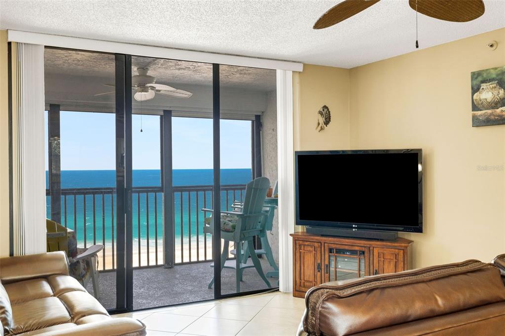 14900 Gulf Boulevard, Unit 410 Madeira Beach, FL 33708 - Photo 28 of 76 a living room with furniture and a flat screen tv