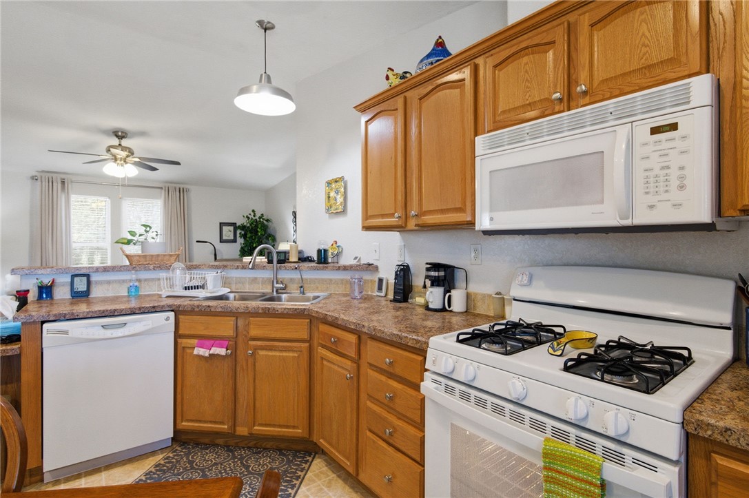 4342 Cordes Road Golden Valley, AZ 86413 - Photo 24 of 39 a kitchen with a stove a sink and a microwave
