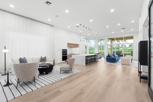 a living room with furniture wooden floor and a table
