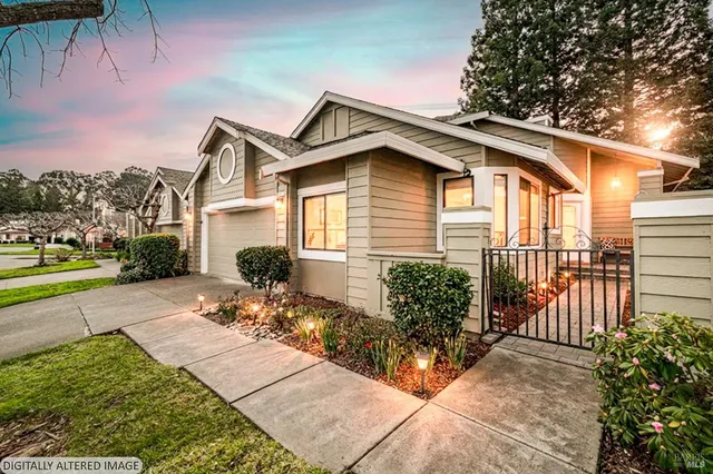a view of a house with backyard and sitting area