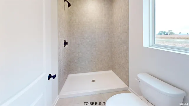 a bathroom with a toilet and shower