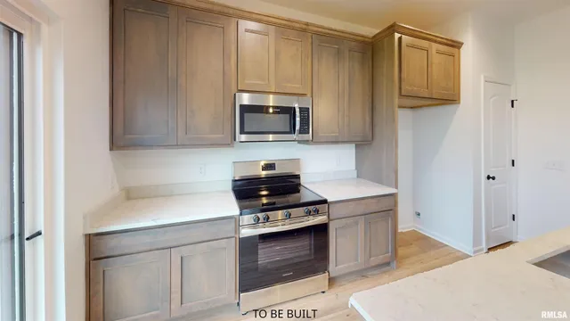 an empty room with a window and wooden floor