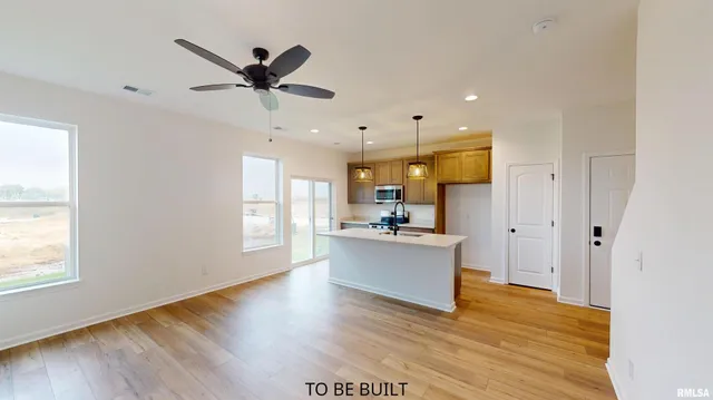 a view of kitchen with sink refrigerator and window